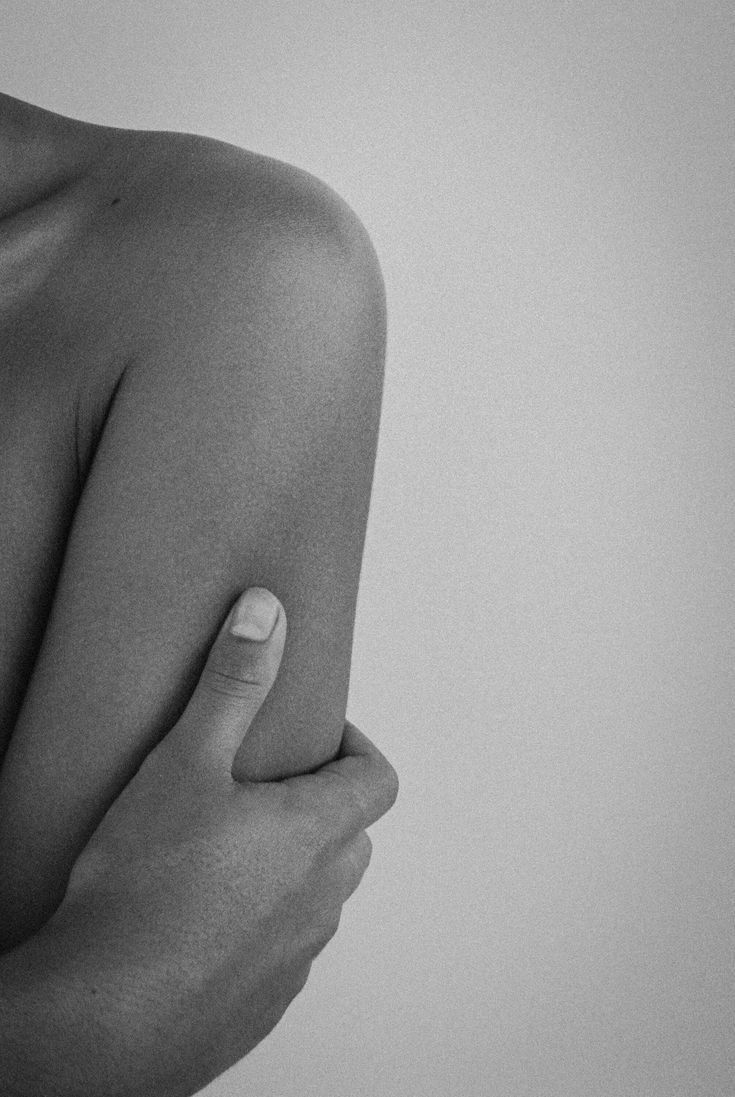 A quiet gesture of care, hand resting on an arm